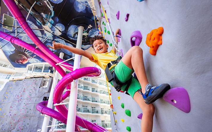 Guest climbing a Royal Caribbean rock wall